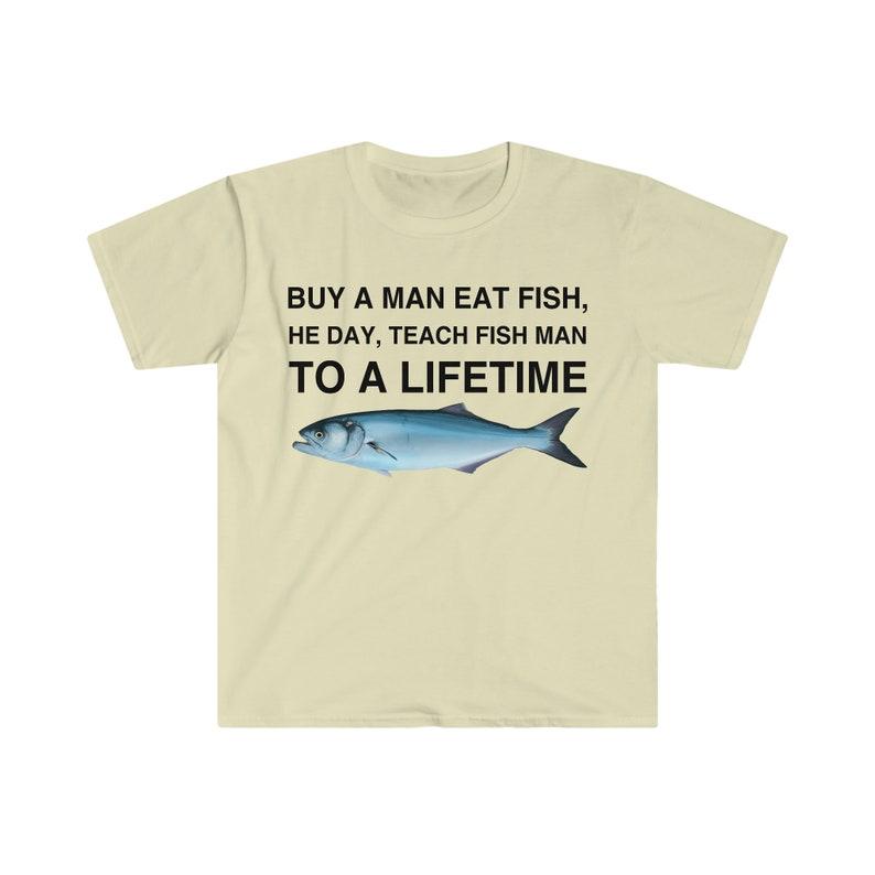 Buy a Man Eat Fish T-Shirt, He Day Teach Fish Man, Lively Meme T-Shirt for Humor Lovers, Unisex Casual Wardrobe Statement Piece